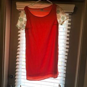 Coral shift dress with beaded floral sleeves.